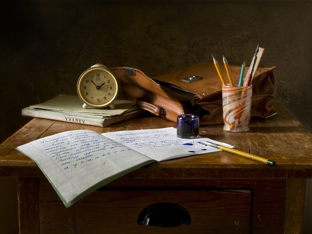 Bag, notebook, pencils, and clock